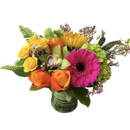 Mixed bouquet of roses, gerbera daisy, and hydrangea in a glass vase
