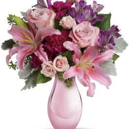 Pink and purple bouquet in a pink glass vase
