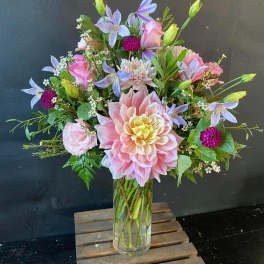 Pink and lavender mixed bouquet in a clear glass vase