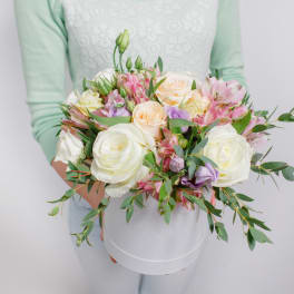 Handheld bouquet of white and pastel roses with pink alstroemeria