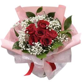 Bouquet of red roses with white baby's breath in pink wrap