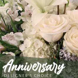 White roses and lilies with hydrangeas in a floral arrangement