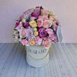 Pink and lavender rose bouquet in a white hat box