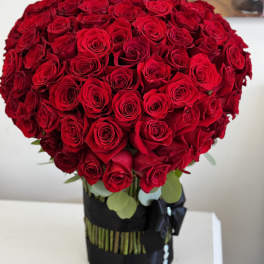 Large bouquet of red roses in a black wrap