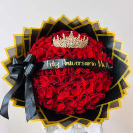 Large bouquet of red roses with a black ribbon and gold crown