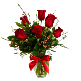Red roses in a glass vase with a red ribbon