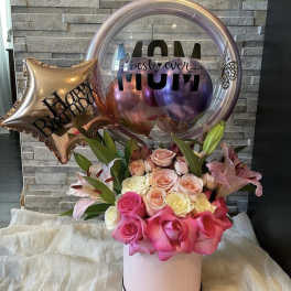 Pink and peach roses in a round box with birthday balloons