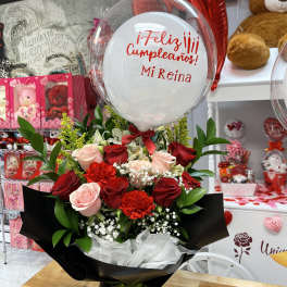 Red and pink rose bouquet with a birthday balloon
