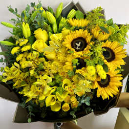 Yellow bouquet with sunflowers, roses, lilies, and orchids