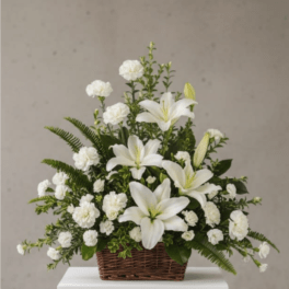 White lilies and carnations in a wicker basket