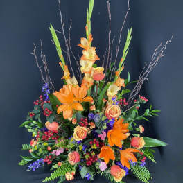 Tall floral arrangement with orange lilies and peach roses