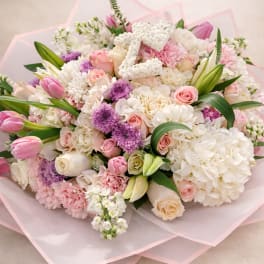 Pink and white mixed bouquet with roses, tulips, and hydrangeas