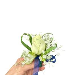White rose boutonniere with baby's breath and blue ribbon