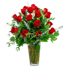 Red roses arranged in a clear glass vase