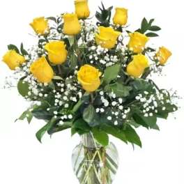 Yellow roses arranged in a clear glass vase with baby's breath