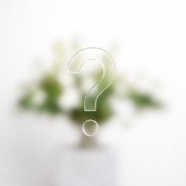 Blurred floral arrangement with a large question mark overlay