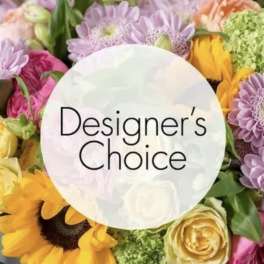 Designer’s Choice floral arrangement with sunflowers, roses, and purple daisies