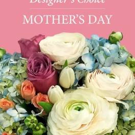 Mother's Day designer's choice bouquet with white flowers, pink roses, peach blooms, and blue hydrangeas