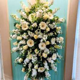 Tall white floral spray with cream roses and daisies
