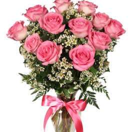 Pink roses in a glass vase with a pink ribbon