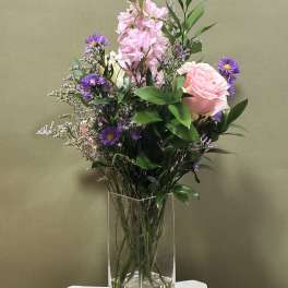 Pink and purple mixed bouquet in a clear glass vase