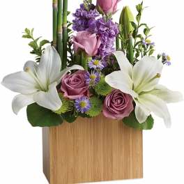 Pink and white lilies with roses in a wooden box