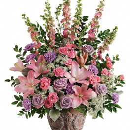 Pink and lavender floral arrangement in an ornate vase