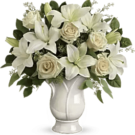 White lilies and cream roses arranged in a white vase