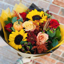 Bouquet of sunflowers and roses wrapped in yellow and black paper