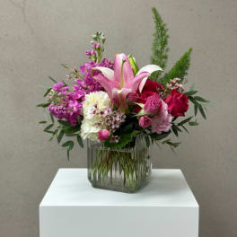 Pink and white floral arrangement in a glass vase