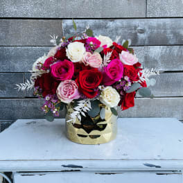 Gold 36 red, pink hot pink and white roses with pink waxflower and dried white ruscus