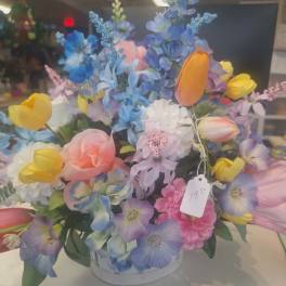 Silk arrangement of pastel tulips and mixed flowers in a white bowl container