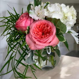Pink roses and white hydrangeas in a glass vase