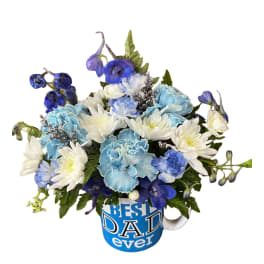 Blue and white flower arrangement in a blue “Best Dad ever” mug
