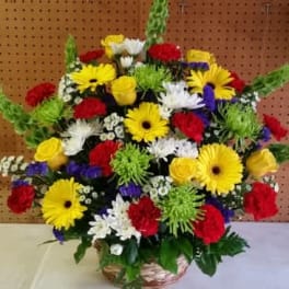 Bright Funeral Arrangment in Wicker