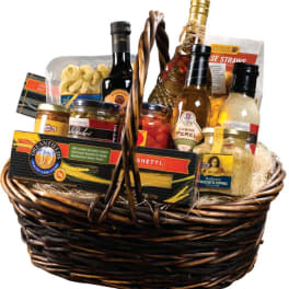 Gift basket with pasta, sauces, and bottles of wine
