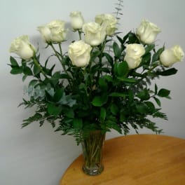 White roses arranged in a clear glass vase