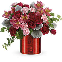 Bouquet of red roses and pink alstroemeria in a red vase