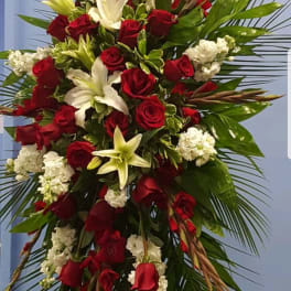 Tall red and white floral spray with palm fronds