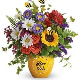Colorful bouquet in a yellow vase with bee decorations and a "Bee Well Soon" message