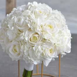 Round bridal bouquet of white roses and hydrangeas with wrapped stems