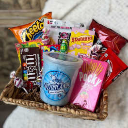 Basket of assorted candy and snacks with a cotton candy tub