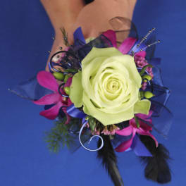 Corsage with a pale green rose and pink accents on a wrist