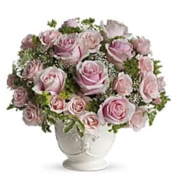 Pink roses arranged in a white vase