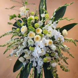 Tall white floral standing arrangement with roses and orchids