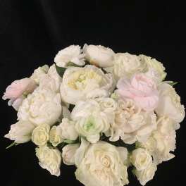 Bouquet of white and blush roses and peonies on a black background