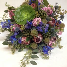 Mixed bouquet with blue and pink flowers and a large green succulent