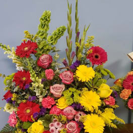 Colorful mixed flower arrangement in a wicker basket