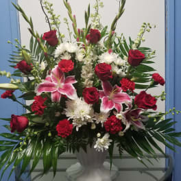 Large vase arrangement with red roses, pink lilies, and white chrysanthemums
