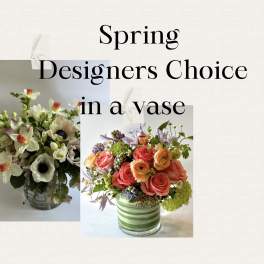 Two mixed flower arrangements in glass vases with spring text above